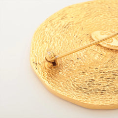 Gold brooch with textured design 