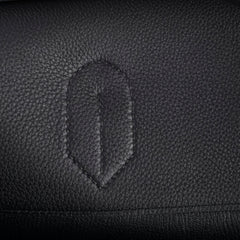 Close-up of a black leather surface with a subtle embossed design.