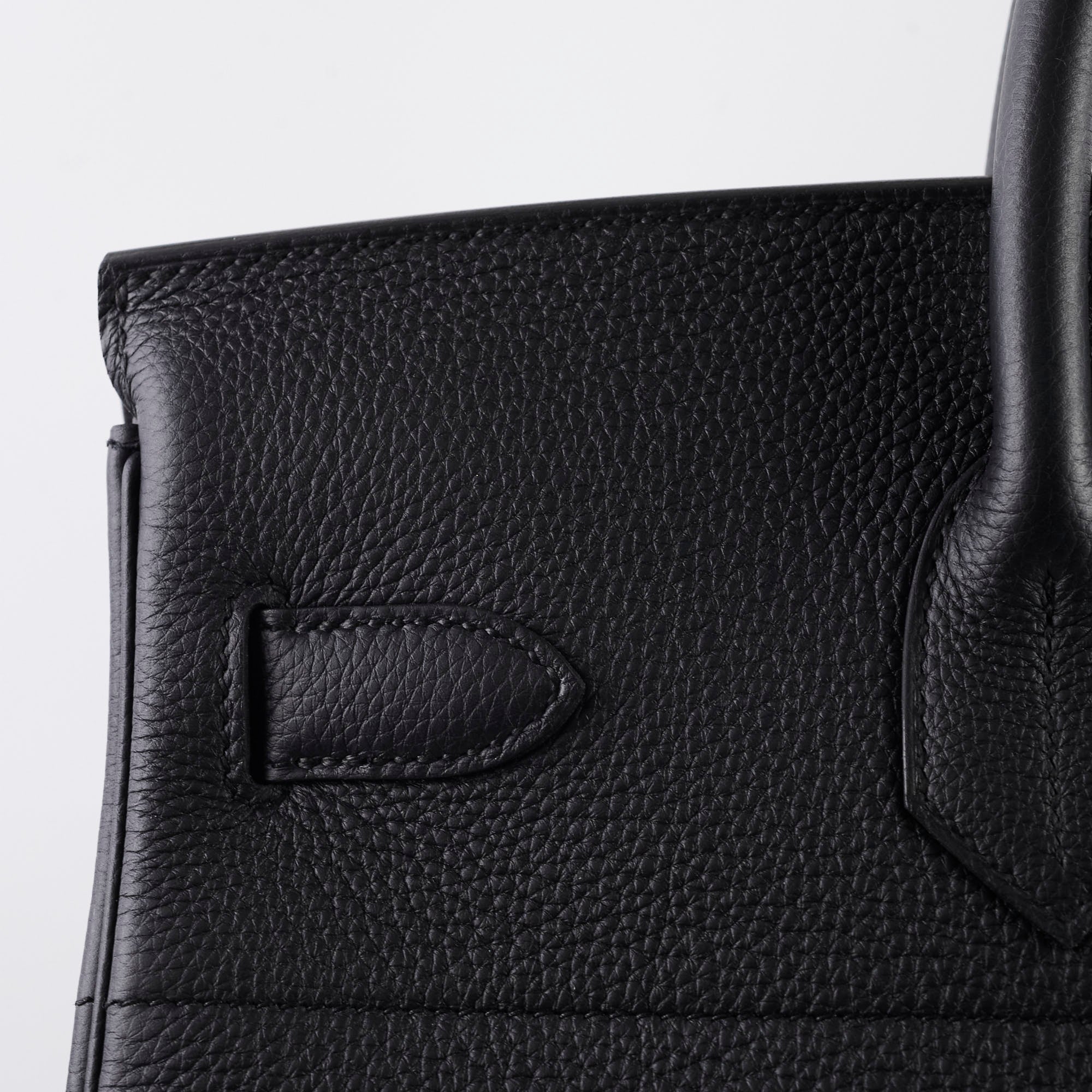 Close-up of a black leather handbag 