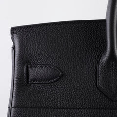 Close-up of a black leather handbag 