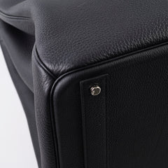 Close-up of a black leather product with a metallic accent 