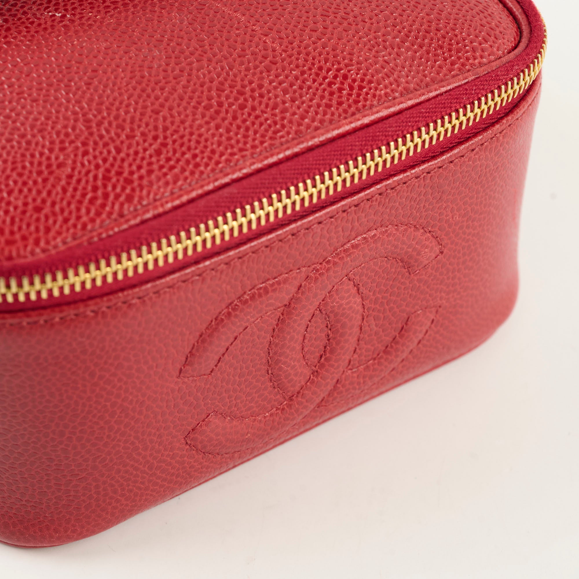 Red leather bag with gold zipper and logo 