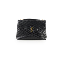Black quilted handbag with a brand 
