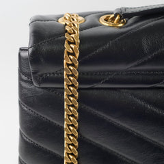 Black quilted handbag with a gold chain strap 