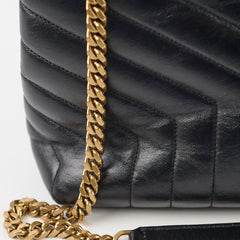 Black quilted handbag with a gold chain strap 