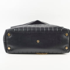 Black leather handbag with gold studs 