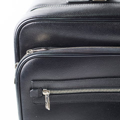 Close-up of a black textured suitcase with zippers 