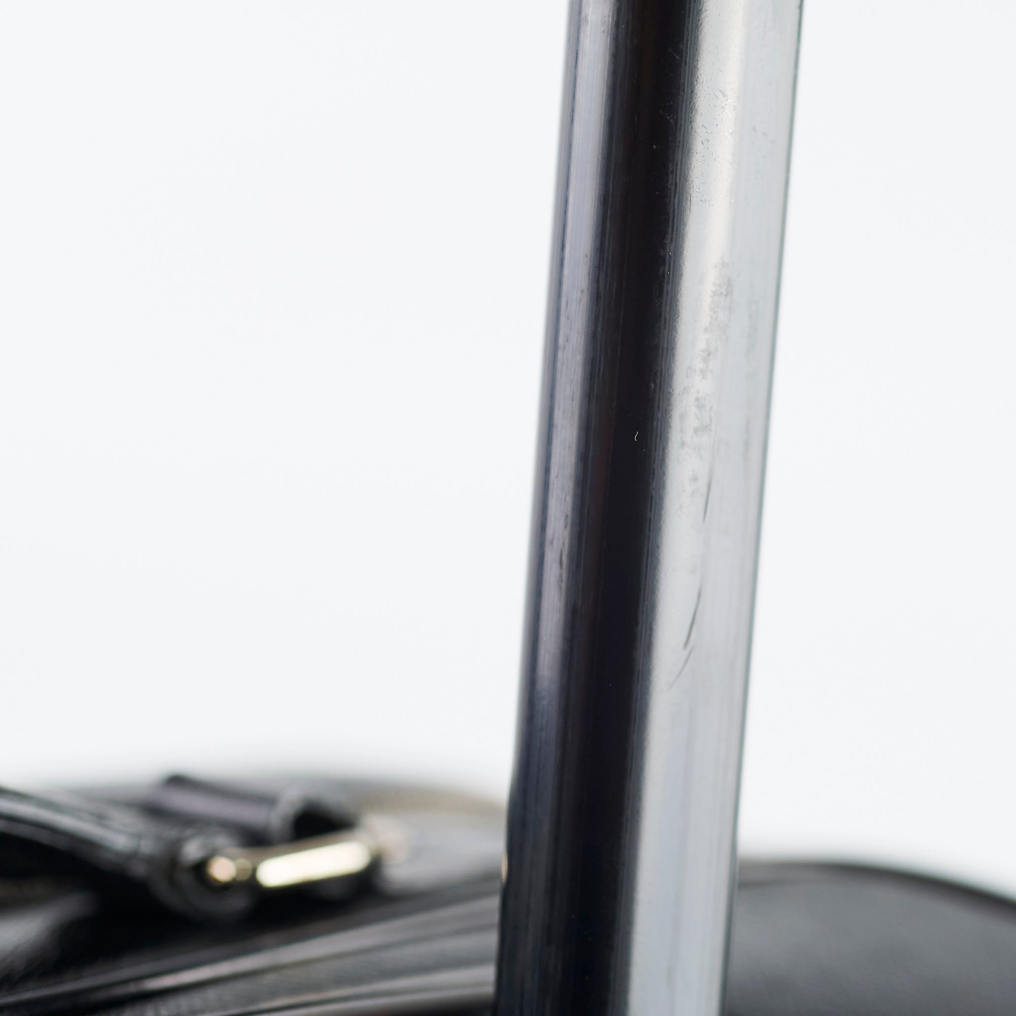 Close-up of a black cylindrical object with a blurred background