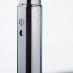 Close-up of a metallic cylindrical object with buttons