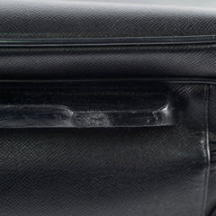 Close-up of a black textured surface with a visible scratch.