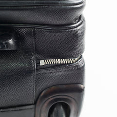 Close-up of a black textured suitcase with a zipper detail 