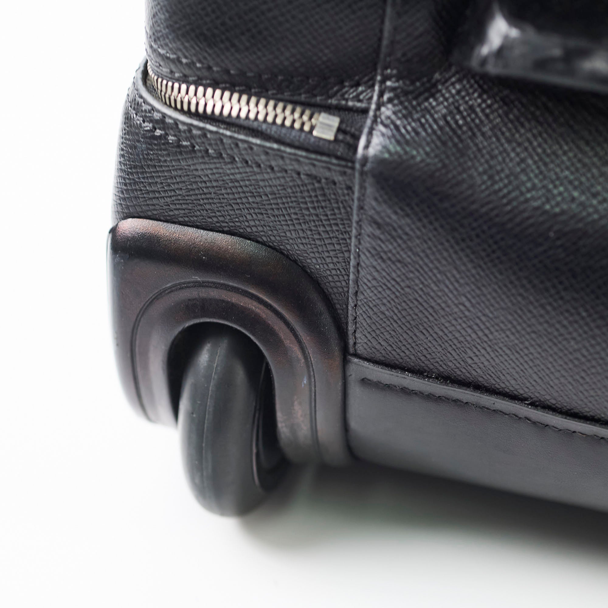 Close-up of a black suitcase wheel 