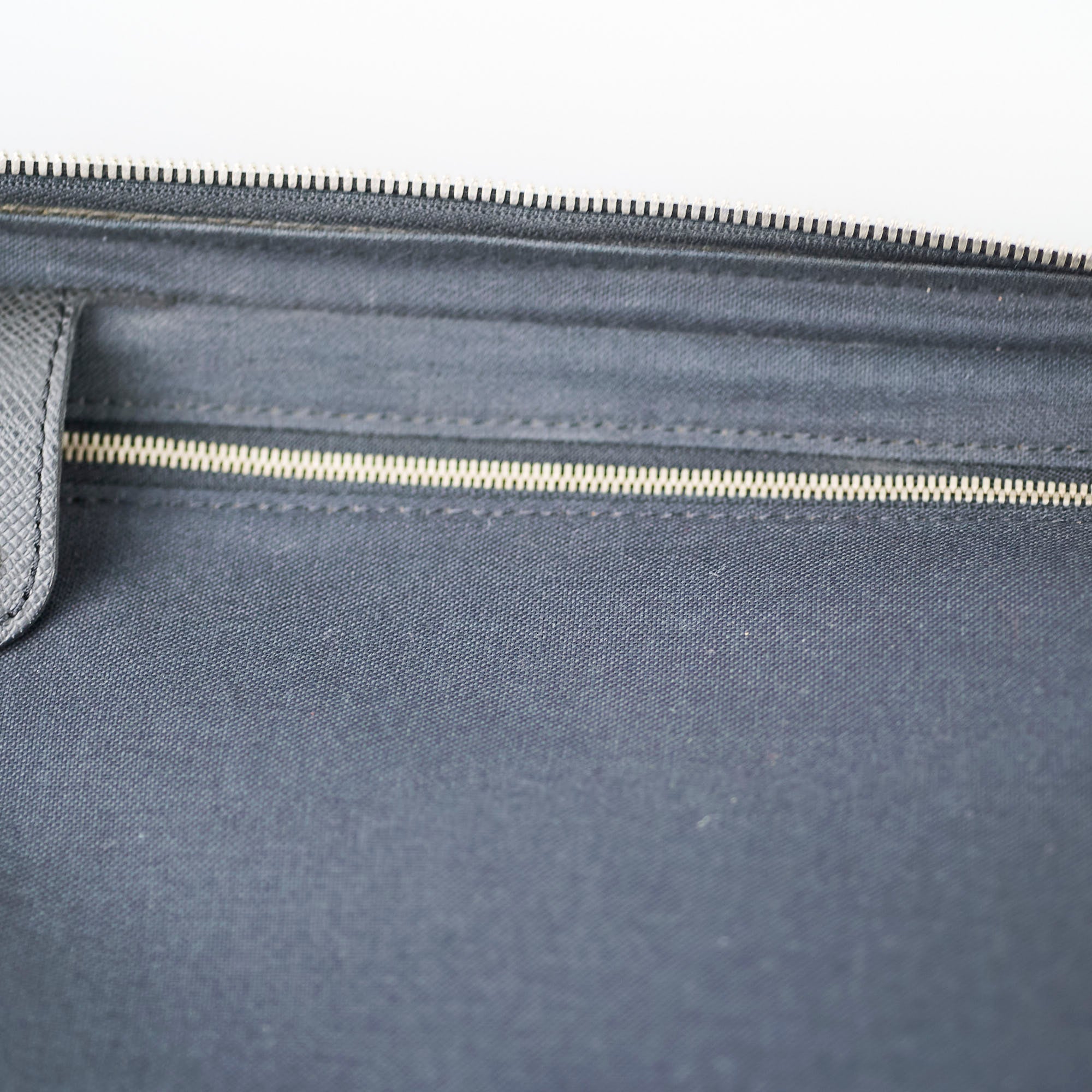 Close-up of a gray bag with a zipper 