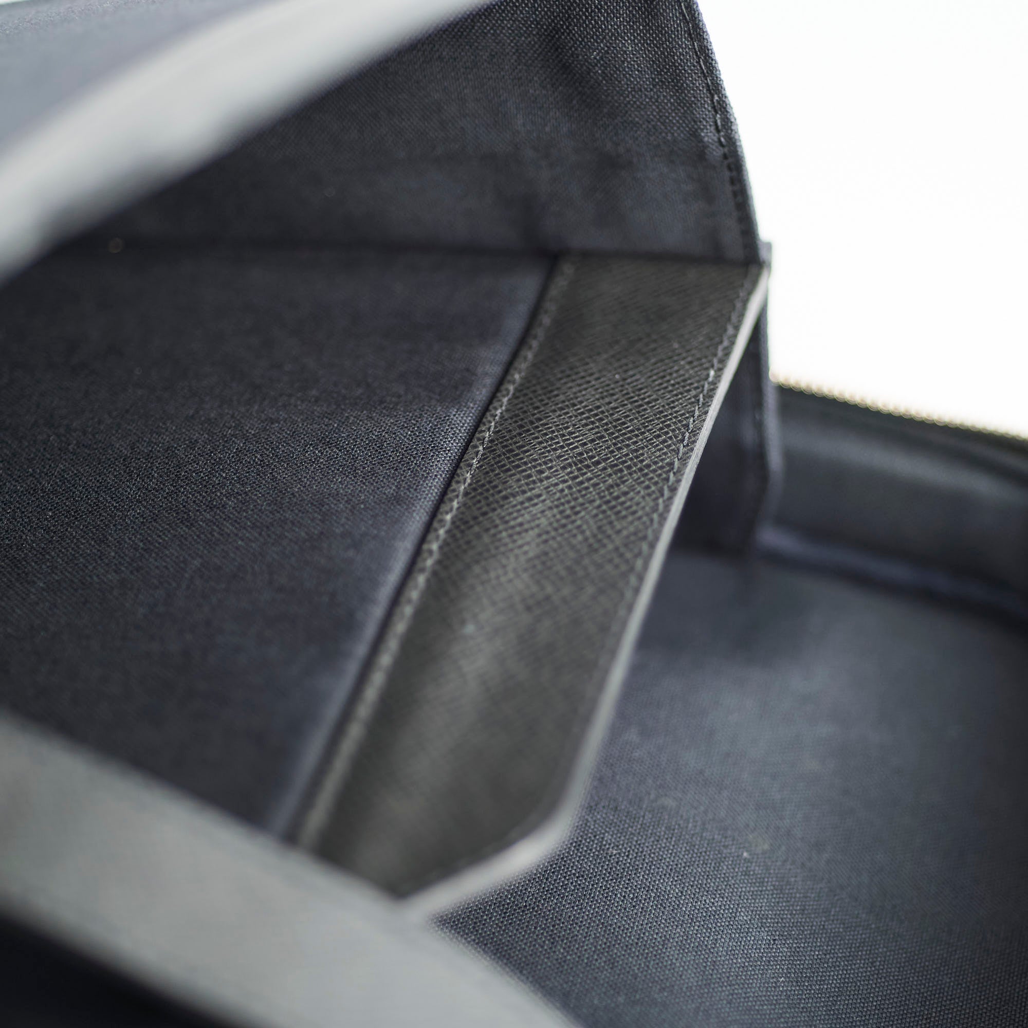 Close-up of a textured black fabric surface with a subtle pattern.