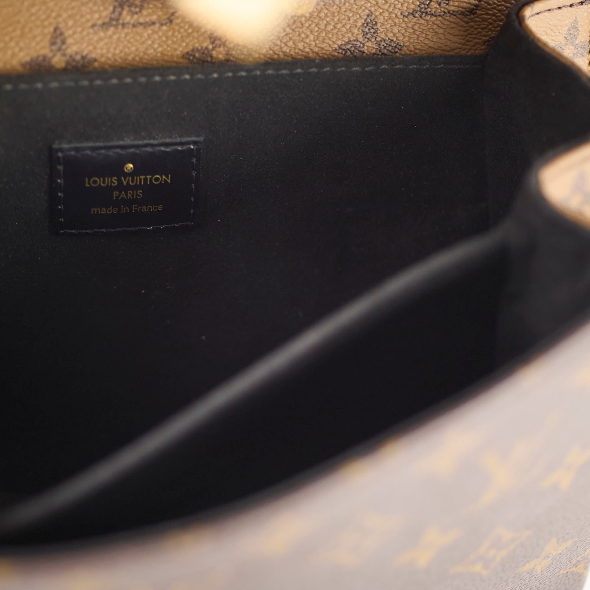 Close-up of a Louis Vuitton bag with a visible brand label.