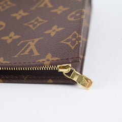 Close-up of a brown wallet with gold zipper and logo 