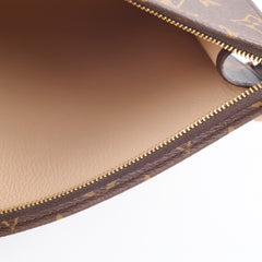 Close-up of a brown leather pouch with gold zipper and pattern, 