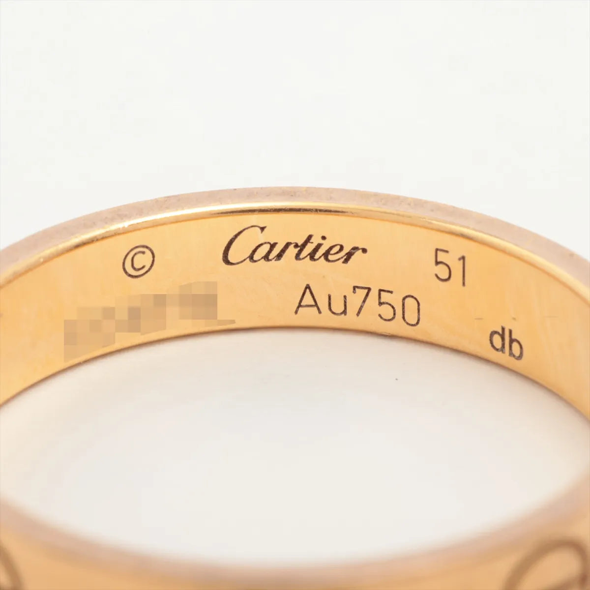 Gold Cartier ring with visible branding and hallmarking 